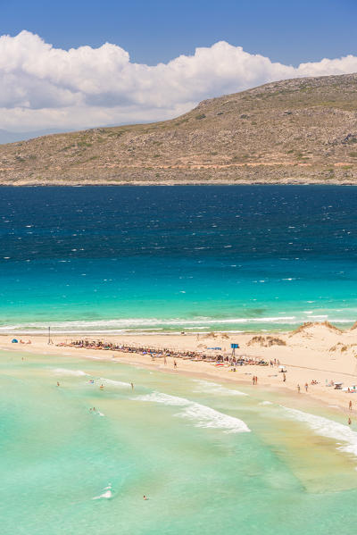 People on the narrow stretch of white sand which divides Simos beach, Elafonissos, Laconia Region, Peloponnese, Greece