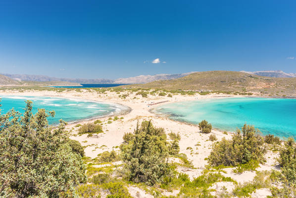 The narrow stretch of white sand which divides Simos beach viewed from a ridge, Elafonissos, Laconia Region, Peloponnese, Greece