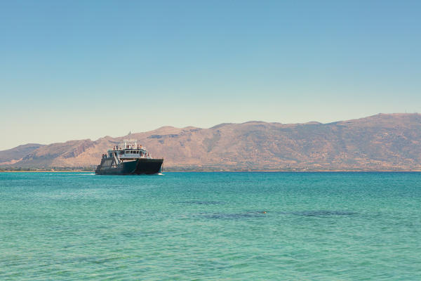 A ferry boat crossing the crystal water near Elafonissos Island,  Elafonissos, Laconia region, Peloponnese, Greece, Europe