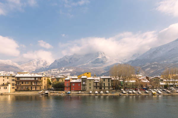 Snowy houses of Pescarenico on Adda river and Resegone mount in the background, Lecco province, Lombardy, Italy