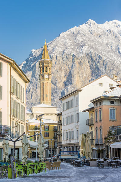 Piazza XX settembre and the iconic bell tower of Lecco with San Martino mount in the background, Lecco province, lombardy, italy
