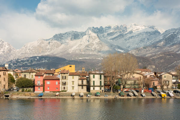 Snowy houses of Pescarenico on Adda river and Resegone mount in the background, Lecco province, Lombardy, Italy