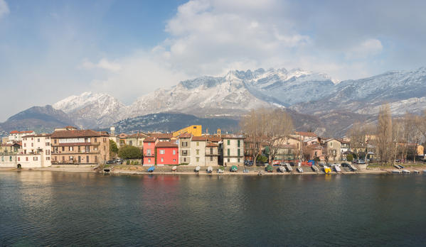 Snowy houses of Pescarenico on Adda river and Resegone mount in the background, Lecco province, Lombardy, Italy