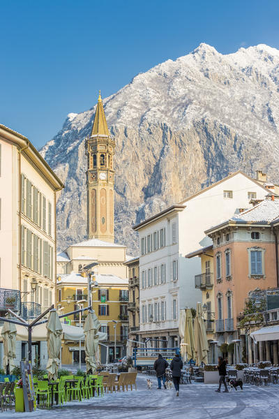 Piazza XX settembre and the iconic bell tower of Lecco with San Martino mount in the background, Lecco province, lombardy, italy