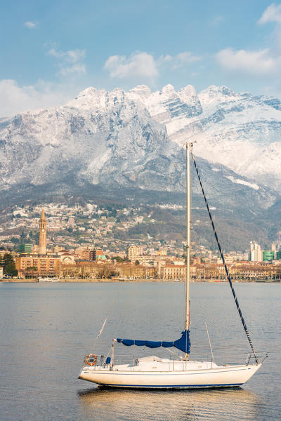 Close up of a boat on Lecco lake with Lecco city and Resegone mount in the background, Lecco province, Lombardy, italy