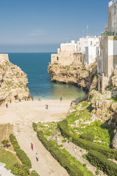 Tourists on Lama Monachile also called Cala Porto, Polignano a Mare, Bari province, Apulia region, Italy