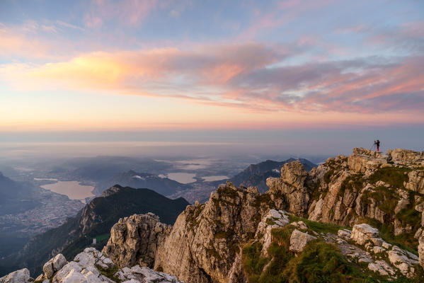 Photographer at the top of Grigna Meridionale at sunrise, Lecco, Lombardy, Italy, Europe