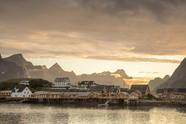 Sunset on the fishing village and mountains in background, Sakrisoya, Nordland county, Lofoten Islands, Northern Norway, Europe