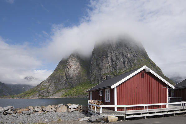 Typical house of fishermen and in backgroud the peak of Hamnøy, Moskenes, Nordland county, Lofoten Islands, Northern Norway, Europe