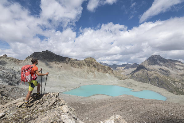Hiker looking the alpine view of Lej Lagrev, Silvaplana, Canton of Graubünden, Engadine, Switzerland, Europe