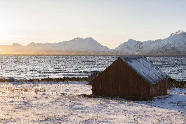 Traditional fisherman house during sunset, Nordmannvik, Kafjord, Lyngen Alps, Tromso, Norway, Europe