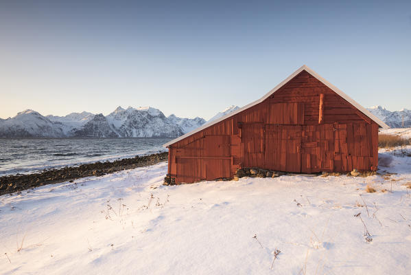 Traditional fisherman house during sunset, Nordmannvik, Kafjord, Lyngen Alps, Tromso, Norway, Europe