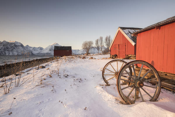 Traditional fisherman houses during sunset, Nordmannvik, Kafjord, Lyngen Alps, Tromso, Norway, Europe