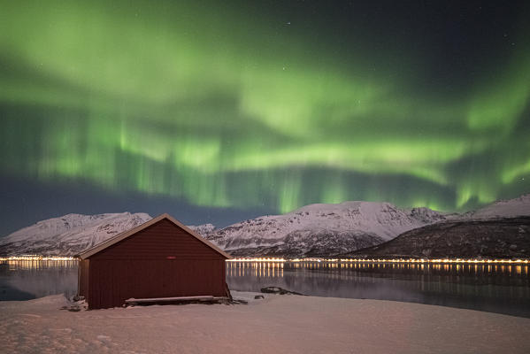 The Northern Lights above a typical Rorbu, Lyngen Alps Tromsø, Norway, Europe