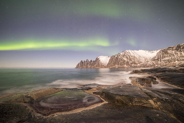 Devil's teeth Mountain illuminated by moon and Northern Lights, Tungeneset, Senja, Tromso, Norway, Europe