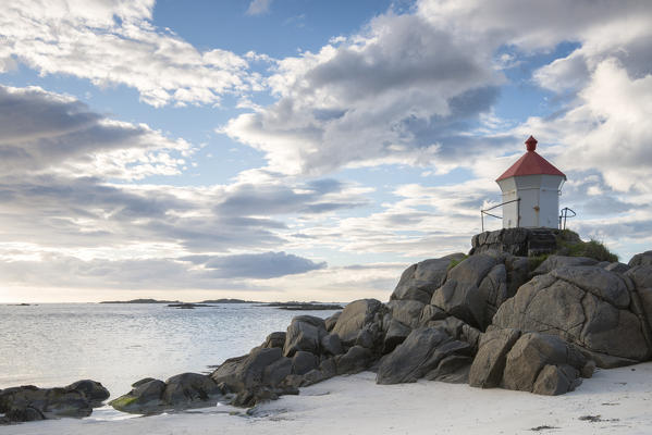 The lighthouse on cliffs surrounded by sea during Midnight sun, Eggum Unstad, Vestvagøy, Lofoten Islands, Norway, Europe