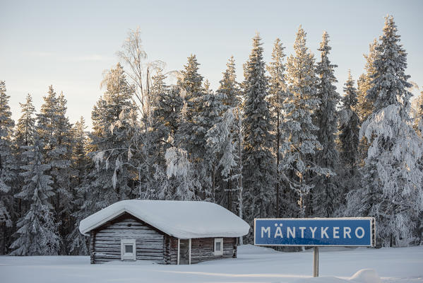 Wooden house in the snowy forest, Kiruna, Norrbotten County, Lapland, Sweden, Europe