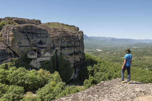 Young man admires Monastery of Ypapanti in Meteora, Kalabaka, Tessaglia, Greece