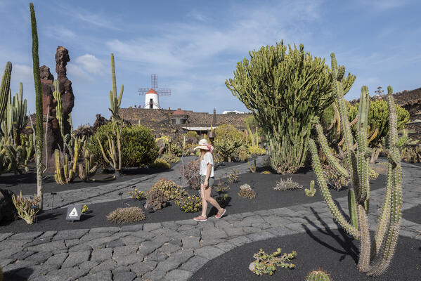 Girl visits the Jardin de Cactus, garden designed by Cesar Manrique in Lanzarote, Lanzarote, Canary Island, Spain, Europe