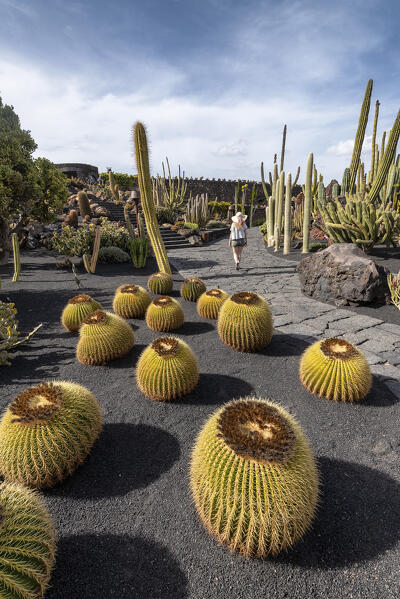 Girl visits the Jardin de Cactus, garden designed by Cesar Manrique in Lanzarote, Lanzarote, Canary Island, Spain, Europe