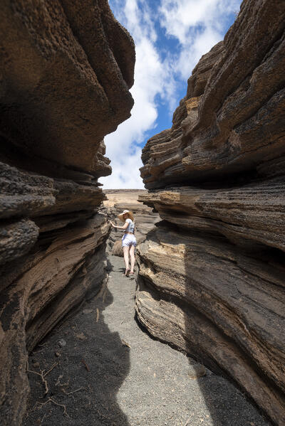 Young girl visits Las Grietas in Lanzarote, Canary Island, Spain, Europe

