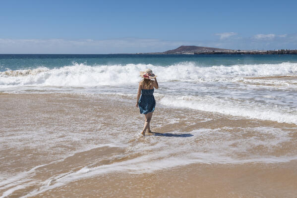 Beautiful girl walks along Papagayo Beach, Lanzarote, Canary Island, Spain, Europe