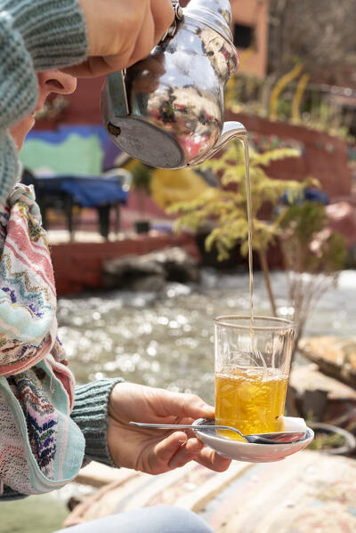 The typical Moroccan tea poured along the banks of the Ourika river at the small village of Sti Fadma in the mountains of Morocco, Morocco, Africa 