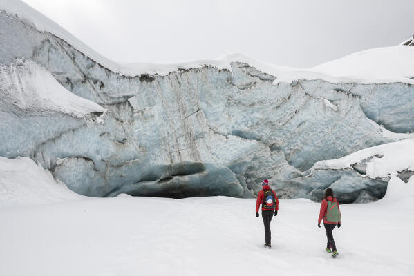Couple of hikers walking towards to Morteratsch glacier,Morteratsch, Engadine, canton of Graubunden, Switzerland 
