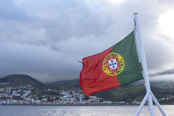 Flag of Azores and Horta village at Faial island in background, Azores, Portugal, Europe
