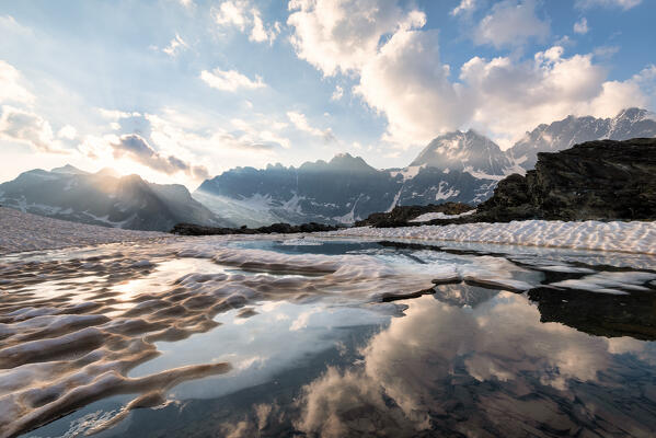 Sunset at lake of Forbici in thaw and group Bernina, Valmalenco, Sondrio province, Lombardy, Italy, Europe