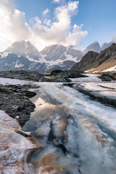 Sunset at lake of Forbici in thaw and group Bernina, Valmalenco, Sondrio province, Lombardy, Italy, Europe
