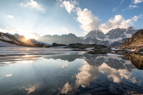 Sunset at lake of Forbici in thaw and group Bernina, Valmalenco, Sondrio province, Lombardy, Italy, Europe