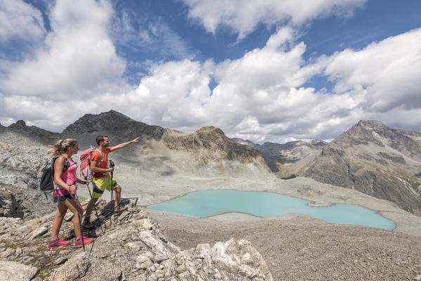 Hikers looking the alpine view of Lej Lagrev, Silvaplana, Canton of Graubünden, Engadine, Switzerland, Europe