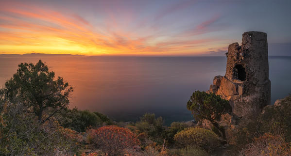 ancient devil's tower at sunrise,Sud Sardinia,Italy. This sighting tower was built in 1639 by the Crown of Spain, and is made of volcanic rock material, andesite and  friezes in calcareous sandstone