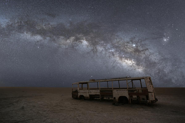 the Milky way over bus wreck in the desert of salt, Chott el-Jérid, Tunisia, Northern Africa.