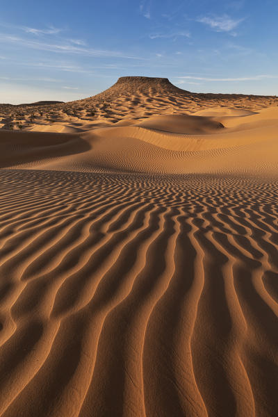 Sunset around Camp Mars village in the sand dunes with Tim Bejin mountain, Sahara desert, Tunisia, Northern Africa.