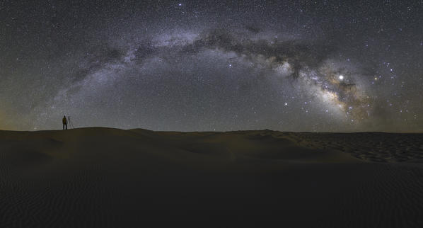 one photographer admiring the milky way in the sand dunes, Sahara desert, Tunisia, Northern Africa.
