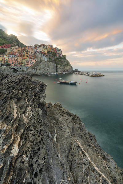 a coloured sunrise on cliffs of Manarola, whit long exposure, National Park of Cinque Terre, Manarola, municipality of Riomaggiore, La Spezia Province, Liguria district, Italy, Europe