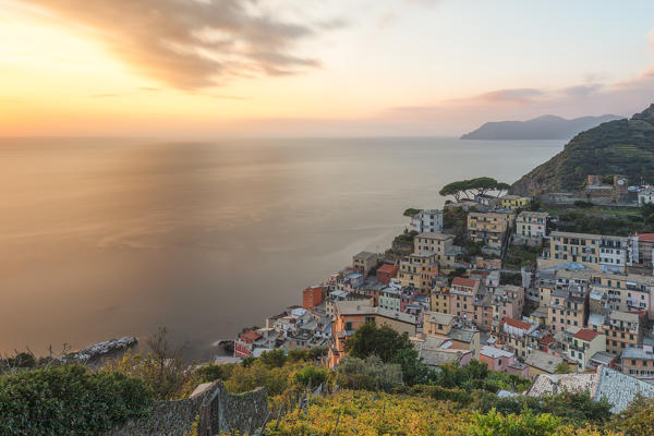 a panoramic view of little town of Riomaggiore at sunset, National Park of Cinque Terre, Manarola, municipality of Riomaggiore, La Spezia Province, Liguria district, Italy, Europe