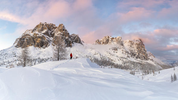 A hiker observes the panorama along the Falzarego Pass, looking at the Tofane and the Lagazuoi, Dolomites, municipality of Cortina d'Ampezzo, Belluno province, Veneto district, Italy, Europe.
