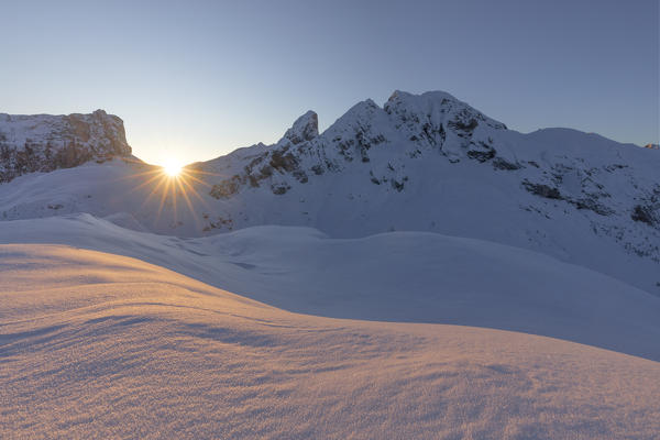 the sun rises behind the Cernera mountain, Dolomites, municipality of Cortina d'Ampezzo, Belluno province, Veneto district, Italy, Europe.
