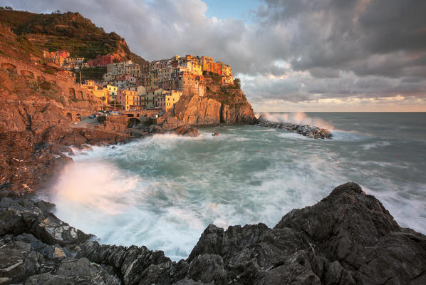 sea storm in cold autumn morning, town of Manarola, municipality of Riomaggiore, Cinque Terre, World Heritage Site, La Spezia province, Liguria district, Italy, Europe.