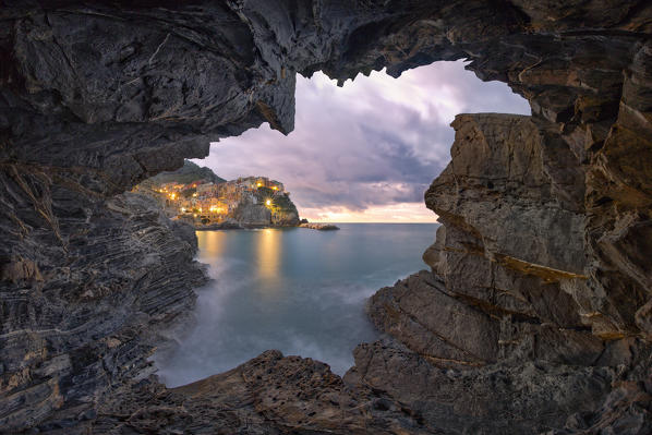 winter sunrise taken from the cave, town of Manarola, municipality of Riomaggiore, Cinque Terre, World Heritage Site, La Spezia province, Liguria district, Italy, Europe.