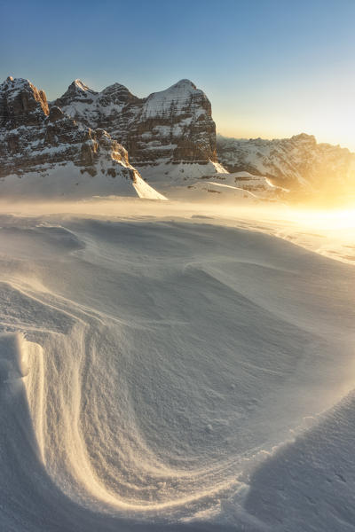 the first rays of the sun hit the Tofana di Rozes a cold and windy winter morning, municipality of Cortina d'Ampezzo, Belluno province, Veneto district, Dolomiti, Italy, Europe