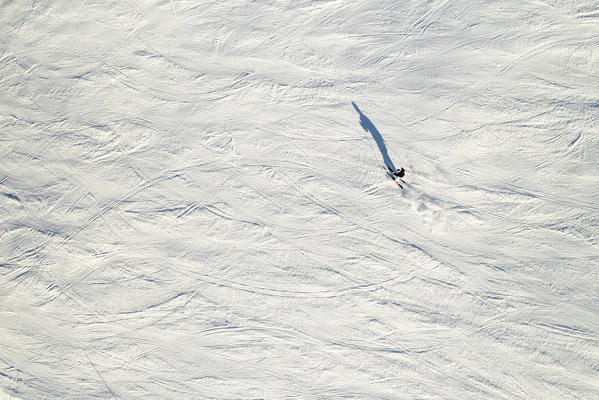 a skier goes down the slopes taken by the drone, Madesimo ski area, Valtellina, municipality of Madesimo, Sondrio province, Lombardia district, Italy, Europe