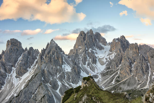 a hiker admires the Cadini di Misurina shrouded in the morning light, Dolomites, municipality of Auronzo di Cadore, Belluno province, Veneto district, Italy, Europe