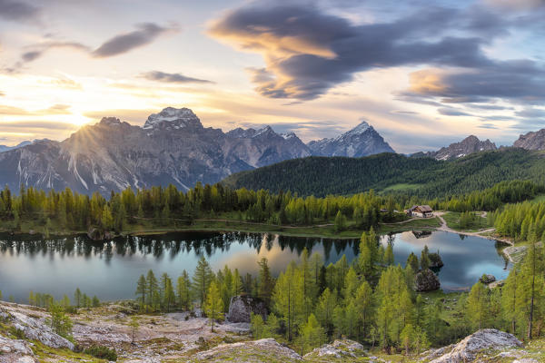 the lenticular clouds frame the Dolomite peaks during a splendid summer sunrise, near the Federa lake, Dolomites, municipality of Cortina d'Ampezzo, Belluno province, Veneto district, Italy, Europe