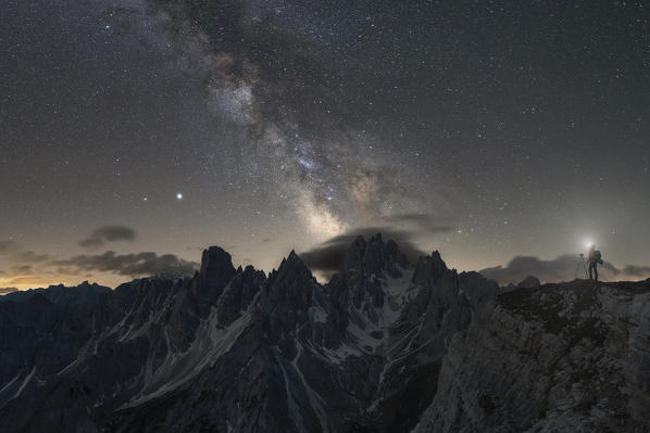 a photographer is intent on taking a photograph of the Milky Way above the Cadini di Misurina, Dolomites, municipality of Auronzo di Cadore, Belluno province, Veneto district, Italy, Europe