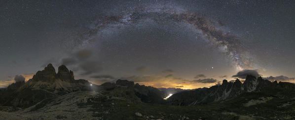 the arc of the Milky Way, which joins the Tre Cime di Lavaredo to the Cadini di Misurina, is taken by a photographer during a magical summer night, Dolomiti, Unesco World Heritage Site, belluno province, Veneto district, Italy, Europe