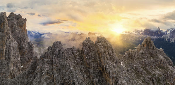 the warm light of the sunset envelops the peaks of the Dolomites, during a summer sunset, Dolomites, municipality of Cortina d'Ampezzo, Belluno province, Veneto district, Italy, Europe